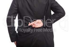 Mid section of a businessman with crossed fingers