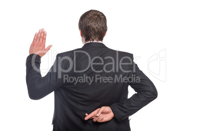 Businessman with crossed fingers and stop gesture