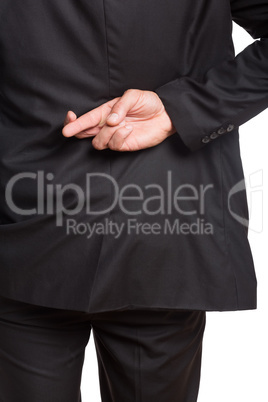 Mid section of a businessman with crossed fingers