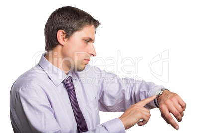 Young businessman looking at wristwatch