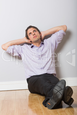 Thoughtful businessman looking up in an empty room