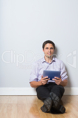 Businessman with digital tablet in an empty room