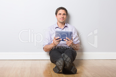 Businessman with digital tablet in an empty room