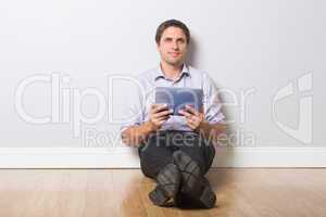 Businessman with digital tablet in an empty room