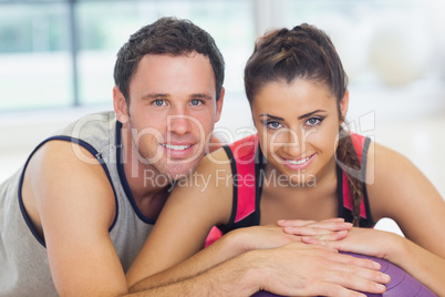 Young woman and man with cropped fitness ball at a gym