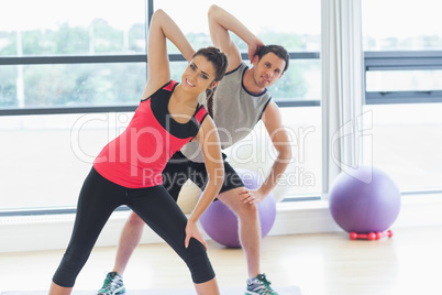 Two people doing power fitness exercise at yoga class