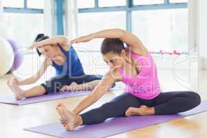 Fit women doing stretching pilate exercises