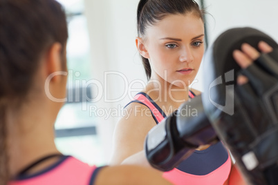 Determined female boxer focused on her training