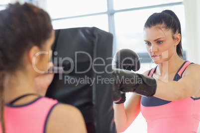 Determined female boxer focused on her training