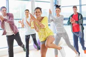 Cheerful fitness class and instructor doing pilates exercise