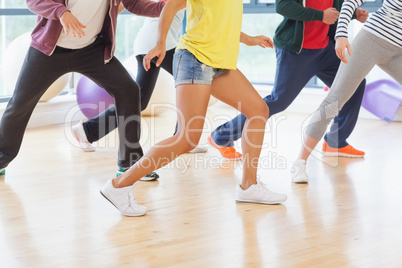 Low section of fitness class and instructor doing pilates exerci