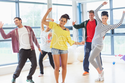 Cheerful fitness class and instructor doing pilates exercise