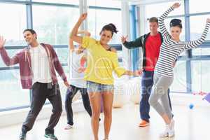 Cheerful fitness class and instructor doing pilates exercise