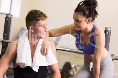 Sporty man and woman chatting in gym