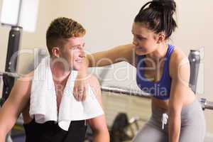 Sporty man and woman chatting in gym