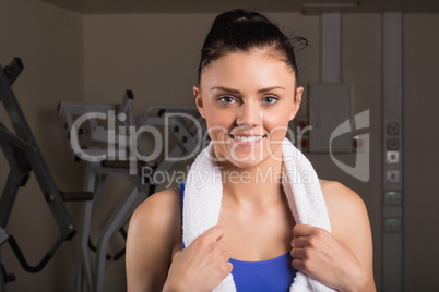 Close-up of a smiling woman with towel in gym