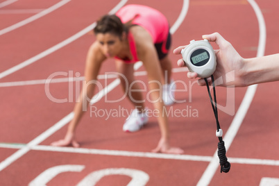 Hand timing a woman's run on the running track