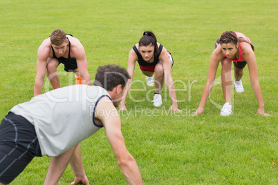 Young people doing stretching exercise at the park