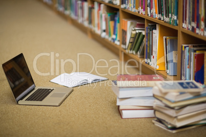 Laptop and books on the library floor