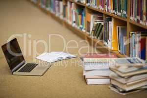 Laptop and books on the library floor