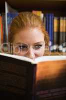 Redhead student reading a book