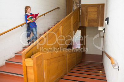 Student reading her notes on the stairs