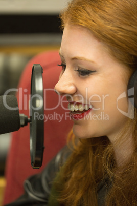 Pretty redhead student presenting a radio show