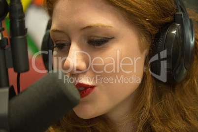 Pretty redhead student hosting a radio show