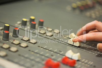 Student working on sound mixer adjusting levels