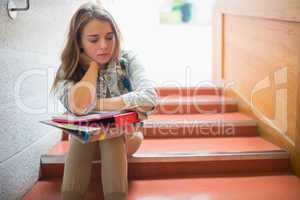 Upset student sitting on stairs