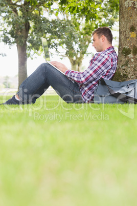 Student using his laptop to study outside