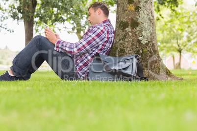 Student using his tablet to study outside