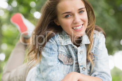 Smiling young girl lying on grass