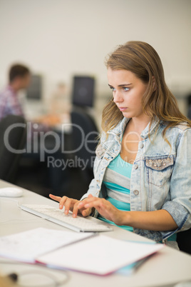 Focused young student studying in the computer room