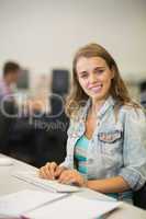 Happy young student studying in the computer room