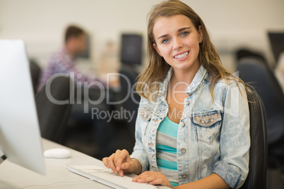 Smiling young student studying in the computer room