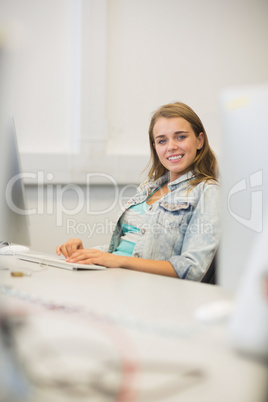 Smiling student studying in the computer room