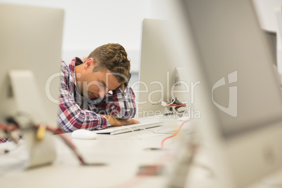 Stressed handsome student studying in the computer room