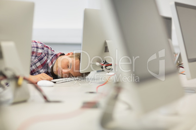 Handsome student napping in the computer room