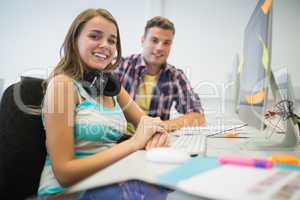 Cheerful classmates doing assignment together in the computer ro