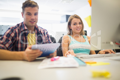 Smiling students working together in the computer room