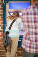 Student taking out money at the atm