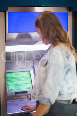 Student entering pin at the atm