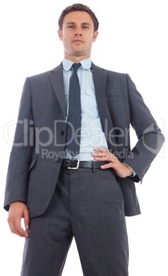 Stern businessman with hand on hip