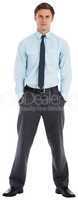 Serious businessman standing with hands in pockets