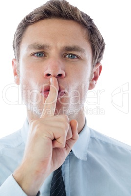 Businessman with finger on lips