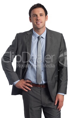 Smiling businessman with hand on hip