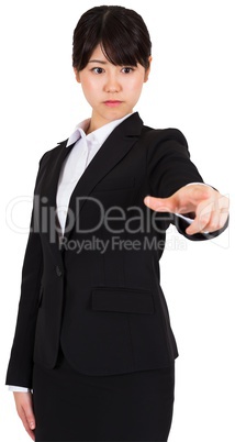 Focused businesswoman pointing