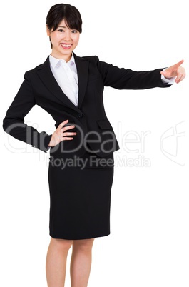 Smiling businesswoman pointing