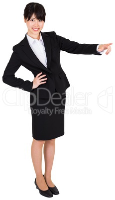 Smiling businesswoman pointing